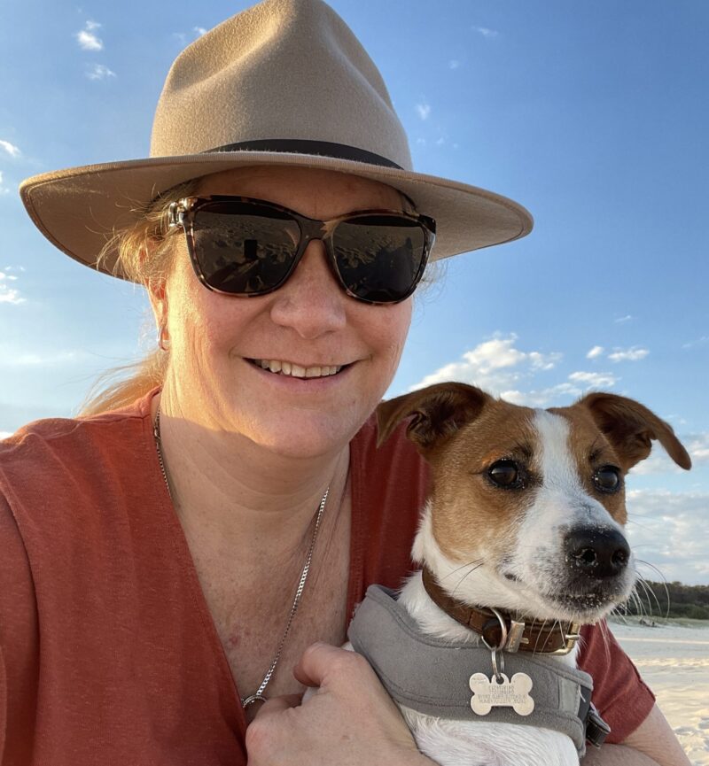 A close up of Sam holding her Jack Russell dog, Rusty.
